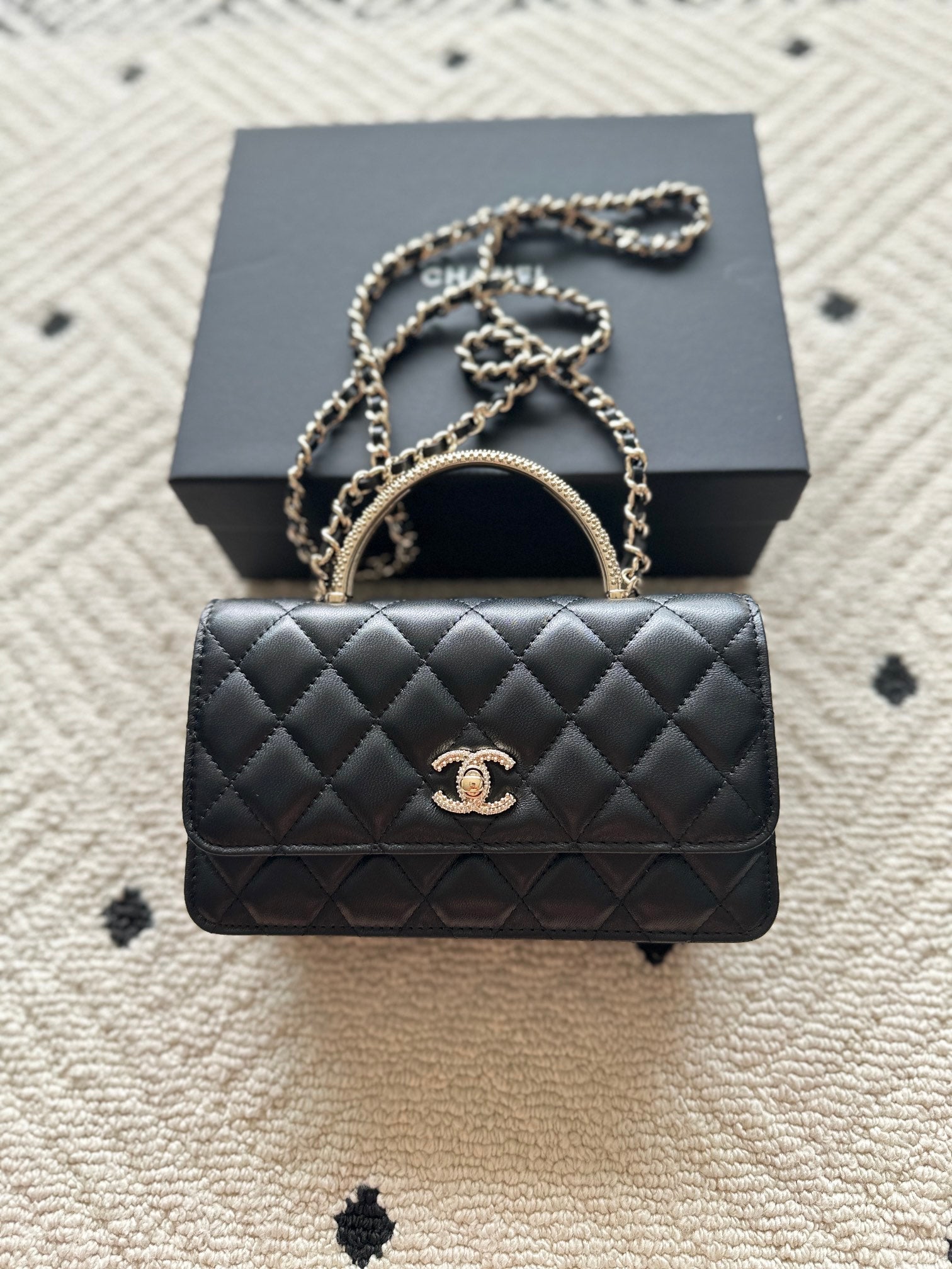 Chanel mini black quilted flap bag with chain strap and gold CC logo