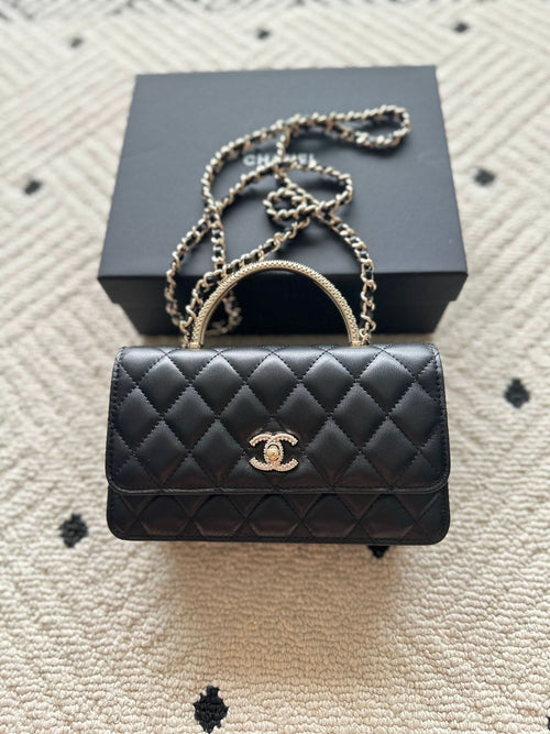 Chanel mini black quilted flap bag with chain strap and gold CC logo