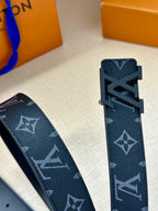 Louis Vuitton belt strap end detail with dark navy monogram finish and cutout buckle area