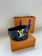 Louis Vuitton belt styled with dark navy monogram strap and oversized silver LV buckle