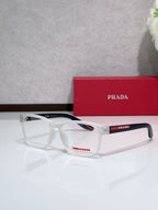 White eyeglasses with Prada logo on temple, rectangular full-rim frame.