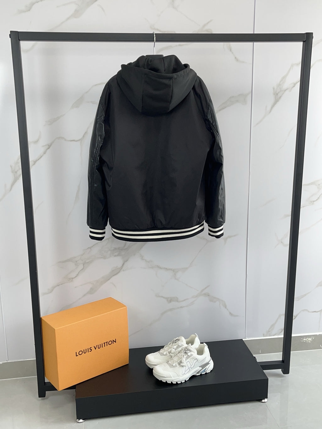 Prada black hooded bomber jacket with striped ribbed cuffs, back view