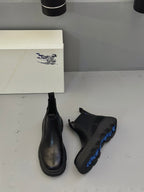 Black Chelsea boots pair with elastic sides and treaded platform sole