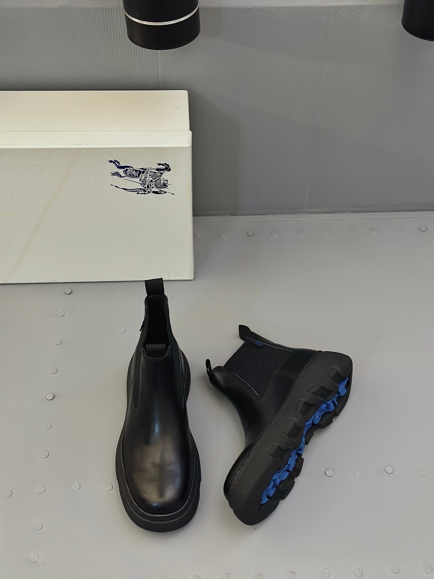 Black Chelsea boots pair with elastic sides and treaded platform sole