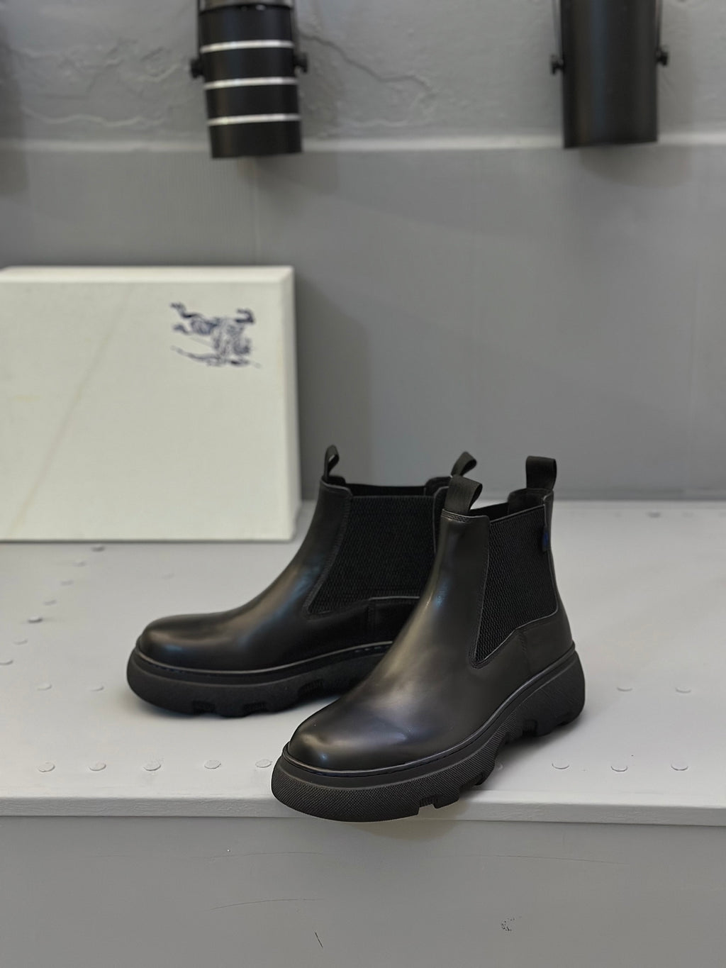 Black Chelsea boots with elastic gores and thick tread sole