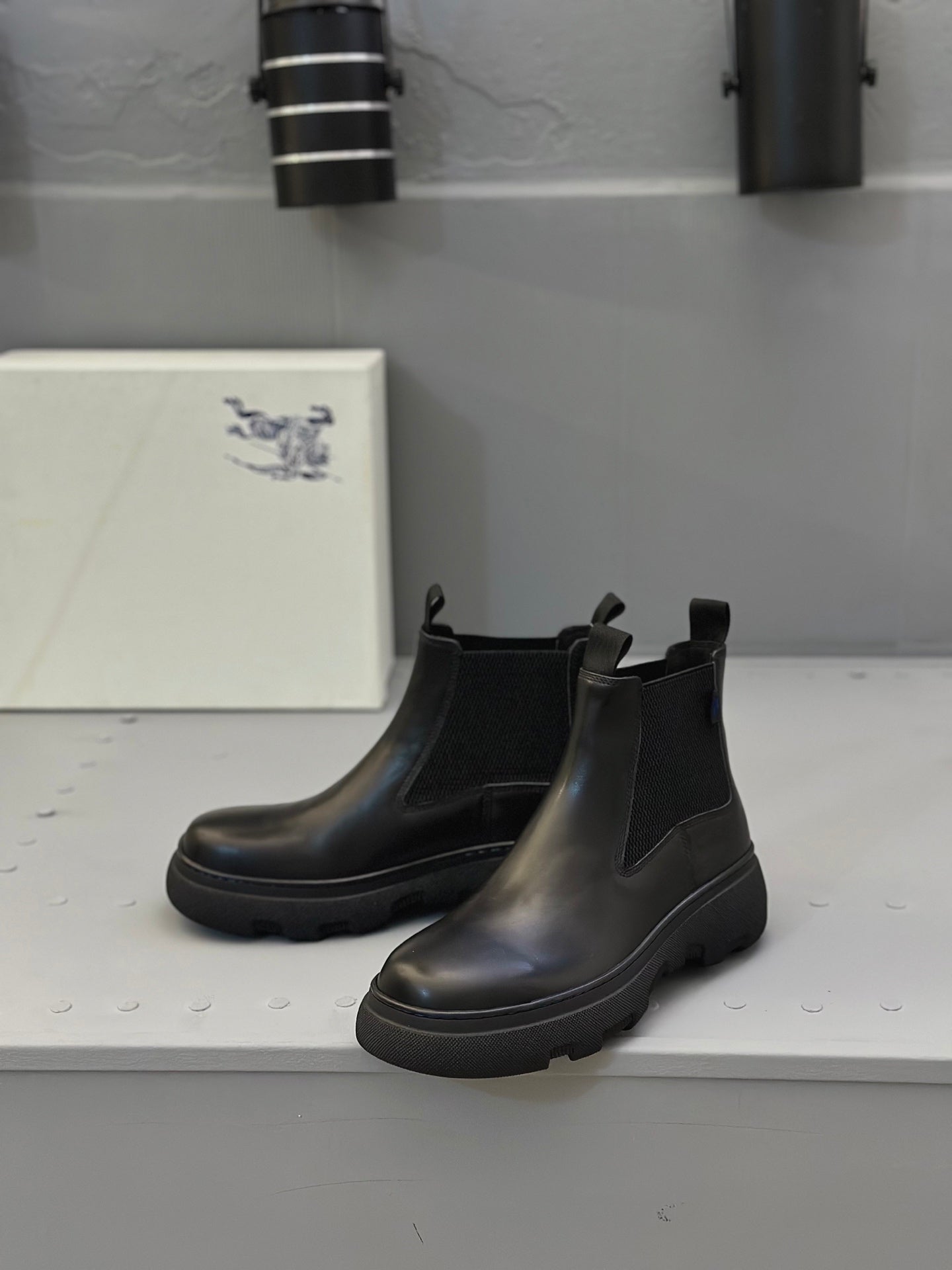Black Chelsea boots with elastic gores and thick tread sole