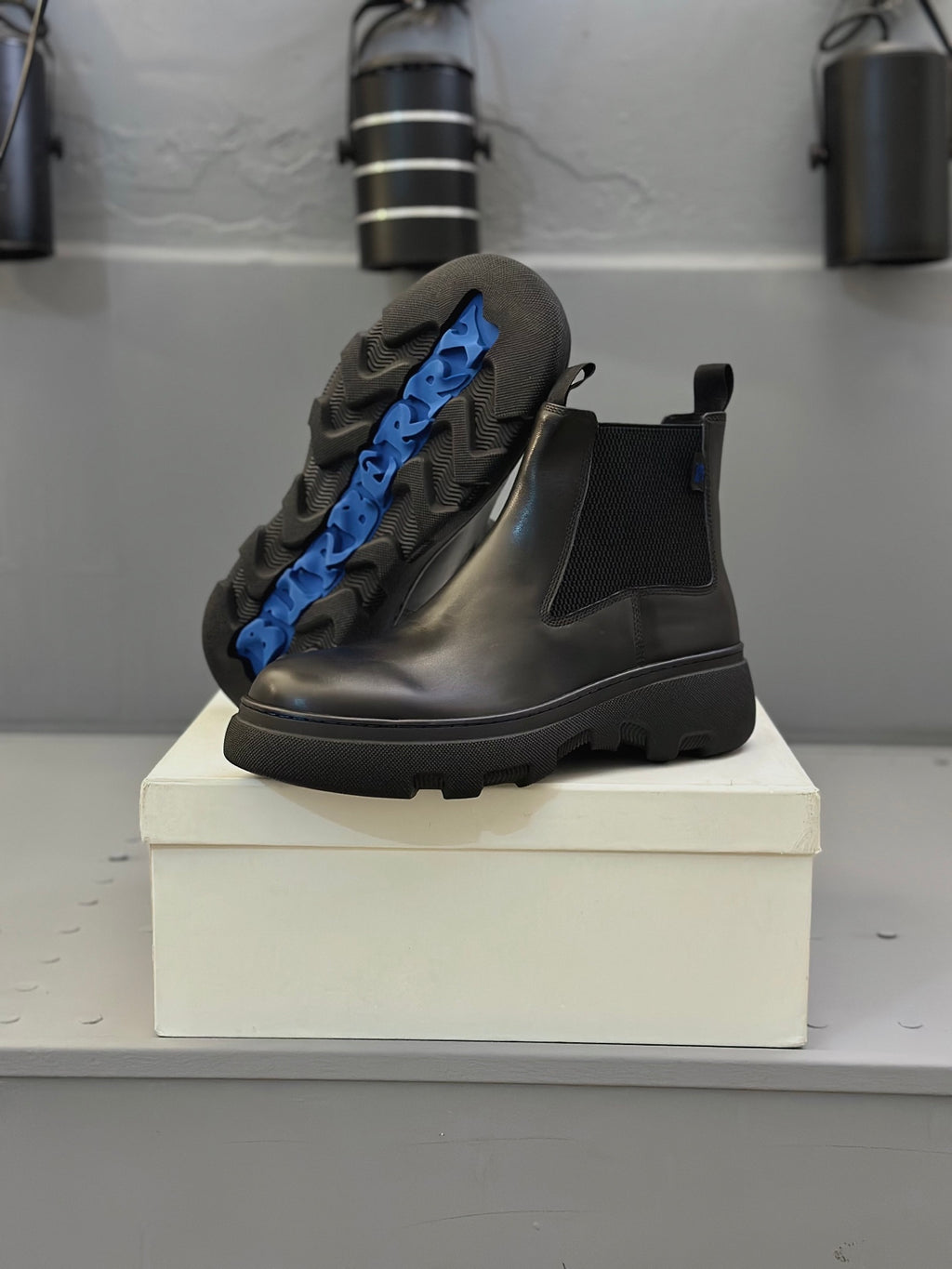Black leather Chelsea boots with blue lining and elastic side panels