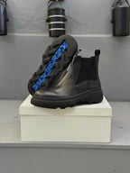 Black leather Chelsea boots with blue lining and elastic side panels