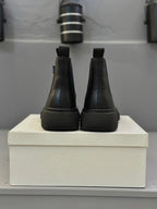 Black Chelsea boots rear view with elastic panels and chunky sole