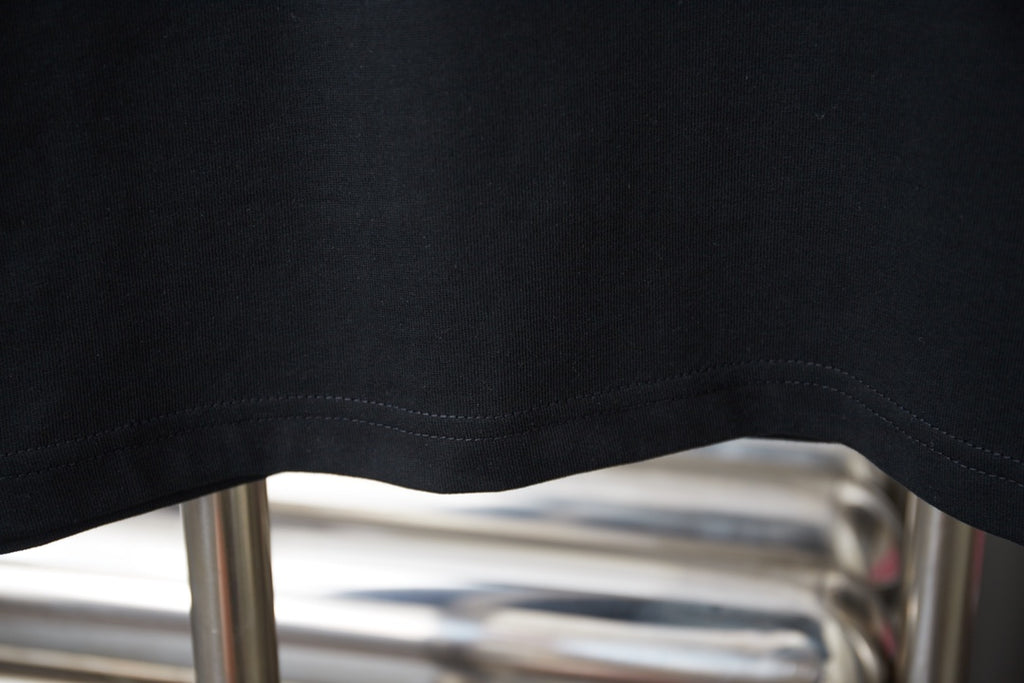 Black Prada T-shirt curved hem close-up