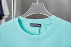 Turquoise crewneck T-shirt with tag at neckline