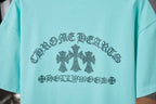 Turquoise short-sleeve T-shirt with centered rhinestone-style text and flower