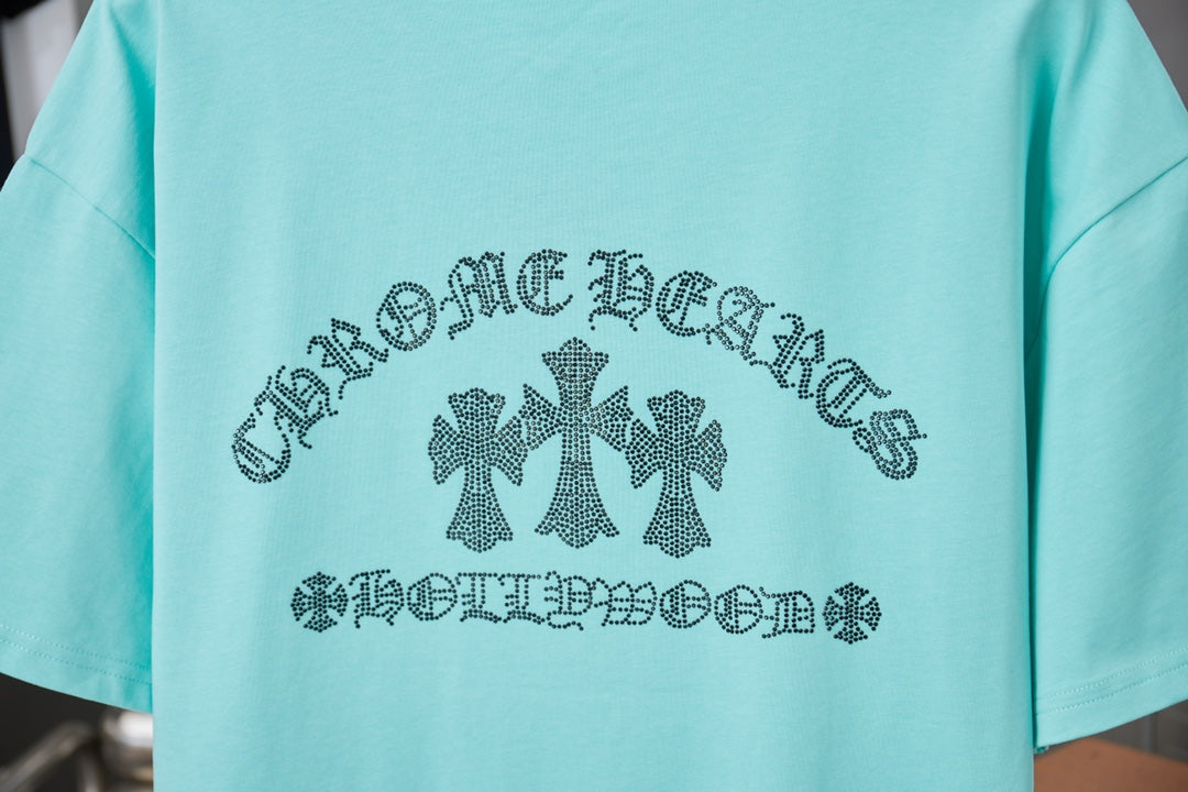 Turquoise short-sleeve T-shirt with centered rhinestone-style text and flower