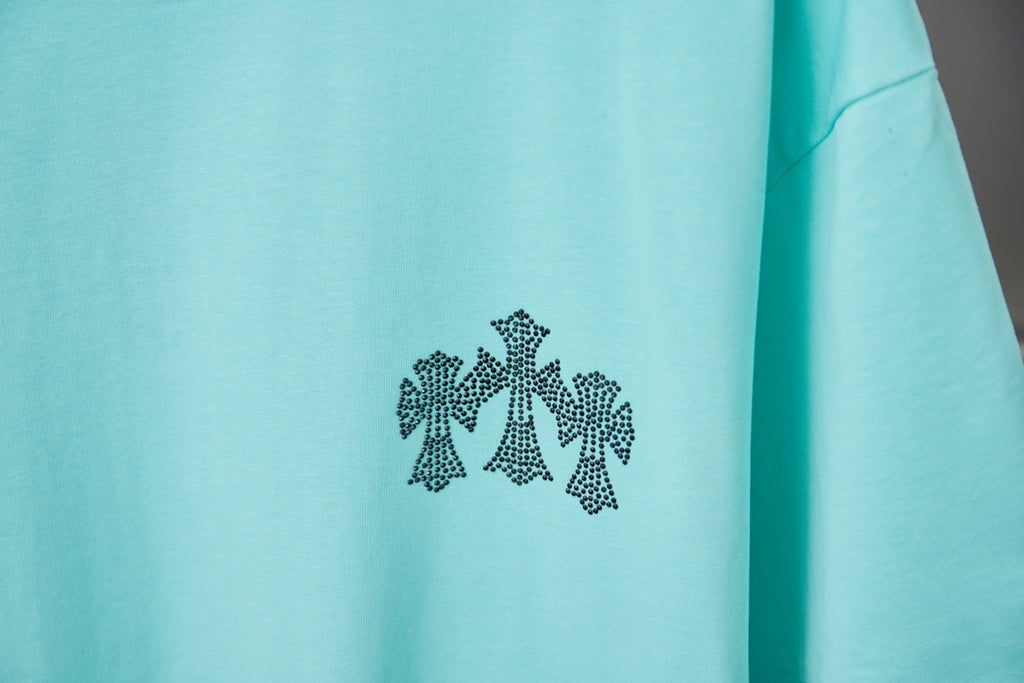 Turquoise short-sleeve T-shirt with small black flower graphic