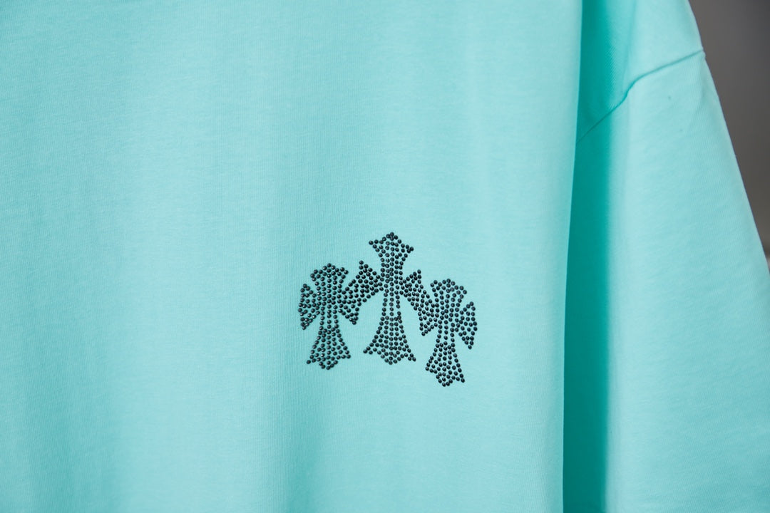 Turquoise short-sleeve T-shirt with small black flower graphic