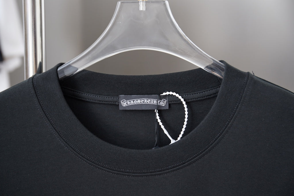 Black T-shirt neckline with ribbed collar and small fabric tag