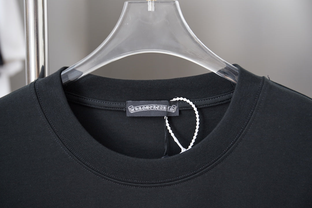 Black T-shirt neckline with ribbed collar and small fabric tag