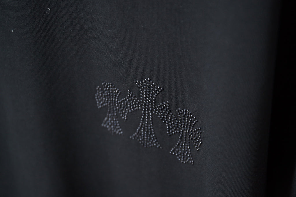 Rhinestone floral applique detail on dark T-shirt chest