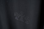 Rhinestone floral applique detail on dark T-shirt chest