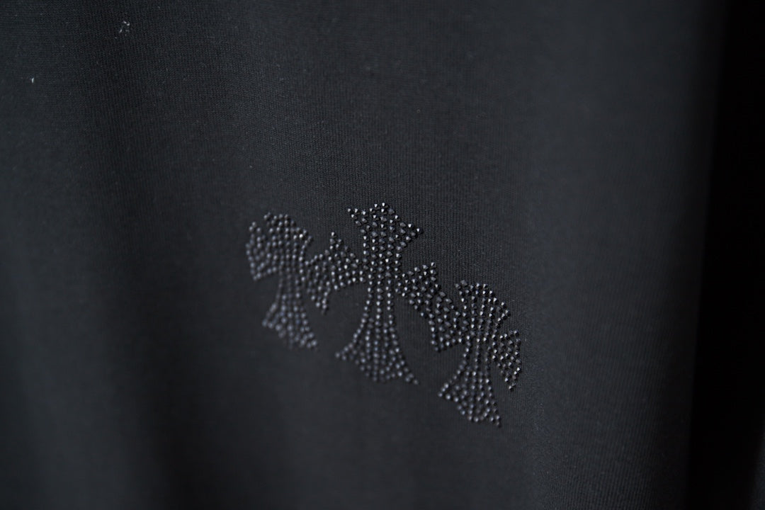 Rhinestone floral applique detail on dark T-shirt chest