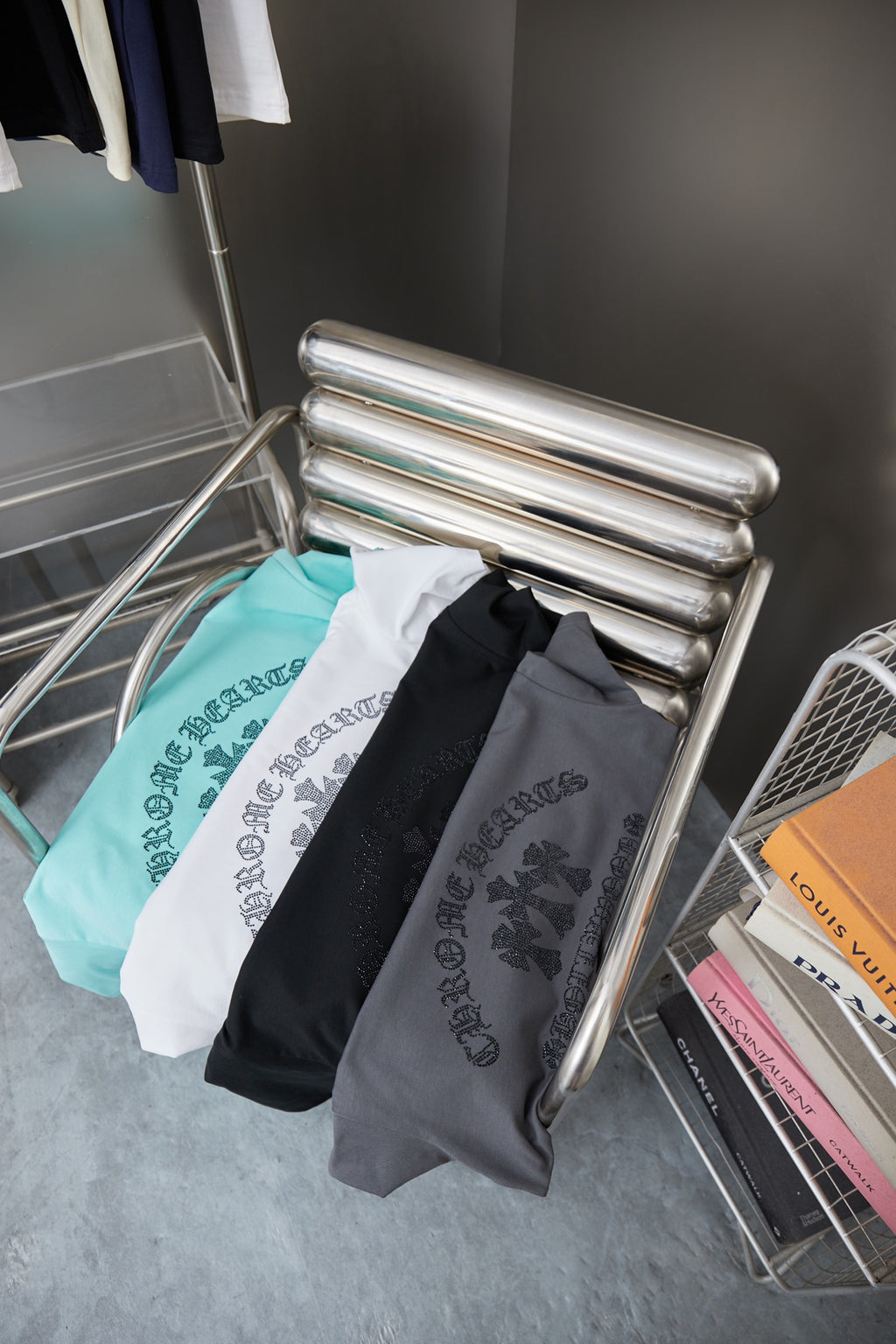 Folded dark and light short-sleeve T-shirts with rhinestone logo print
