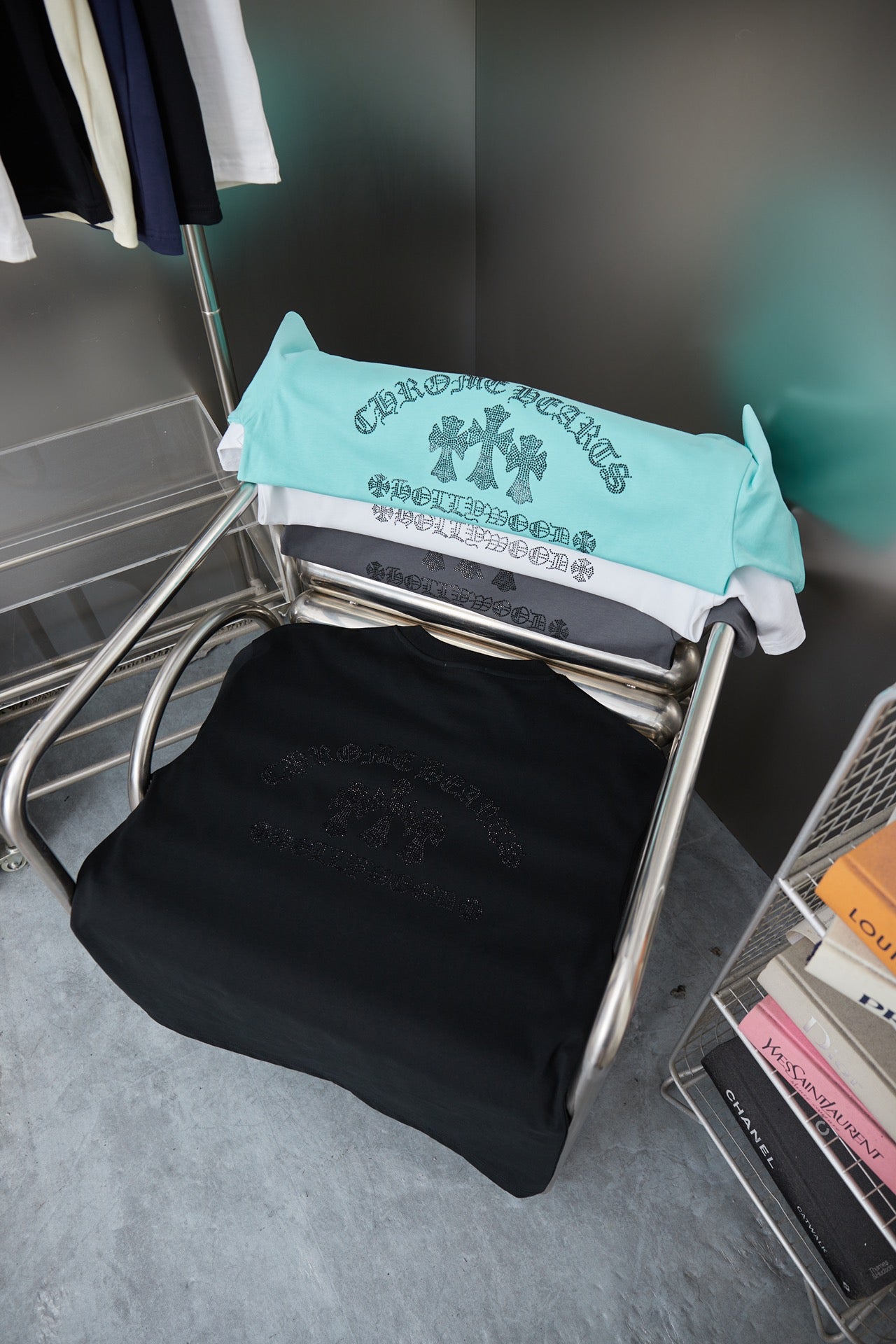 Folded turquoise and dark short-sleeve T-shirts with rhinestone logo print