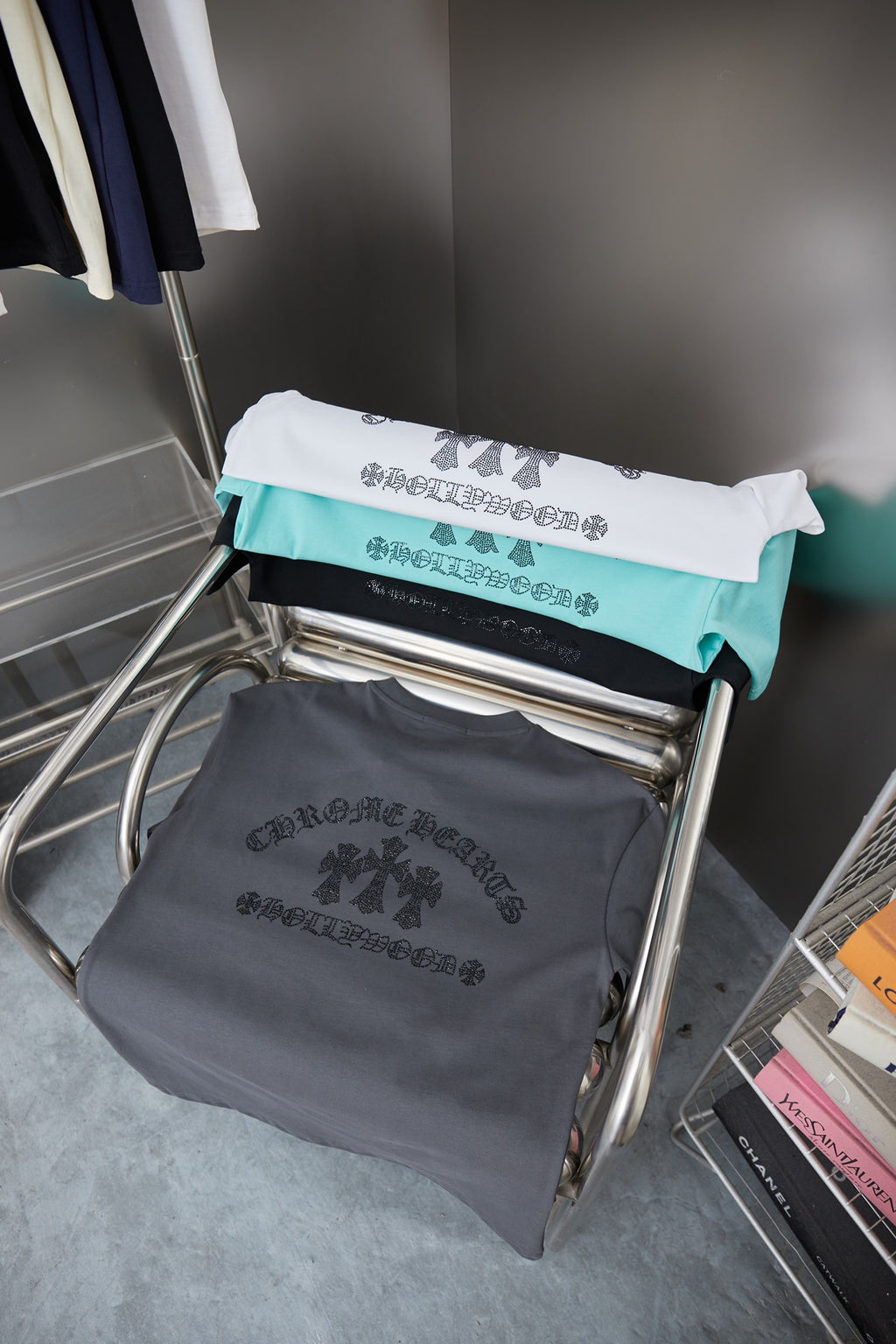 Rhinestone graphic short-sleeve T-shirts on a rack, including dark and white pieces