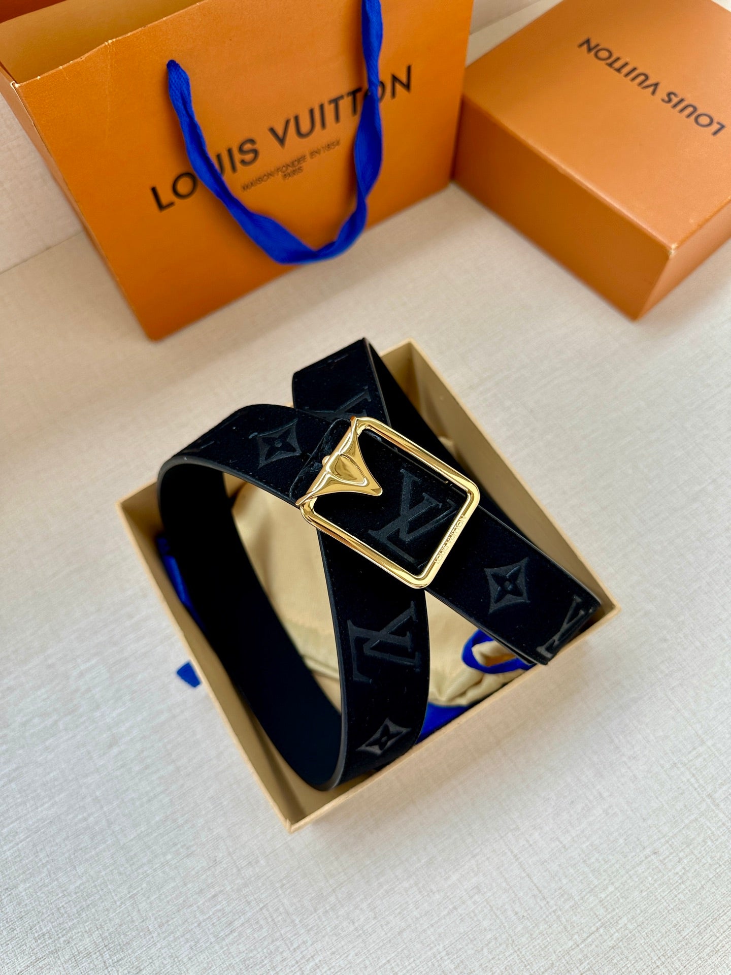 Black monogram belt with gold-tone square buckle and LV-style details