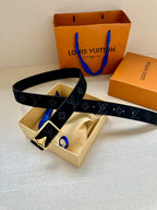 Black monogram belt with gold-tone square buckle, belt looped around