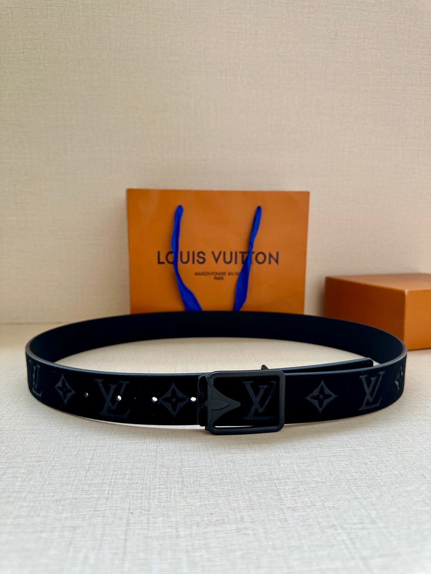 Black monogram belt with rectangular silver-tone buckle