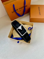 Black monogram belt with silver-tone square buckle, laid flat