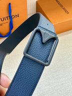Louis Vuitton belt buckle close-up on textured blue leather strap