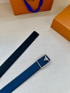 Louis Vuitton belt laid flat with blue strap and silver-tone rectangular buckle