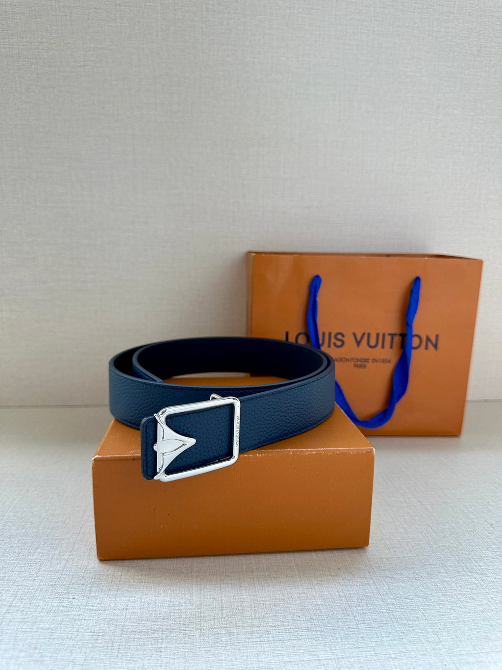 Louis Vuitton belt with blue leather strap and silver buckle