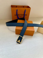 Louis Vuitton belt with blue strap and silver buckle across the belt length
