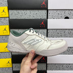 White Balenciaga low-top sneakers with green collar, side logo, and lace-up closure.
