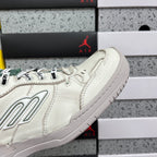 White Balenciaga sneaker side panel with logo, lace-up eyelets, and stitching.