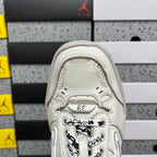 White Balenciaga sneaker toe with lace hardware and perforated leather details.