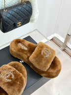 Brown plush slide slippers with Chanel rhinestone CC on front strap