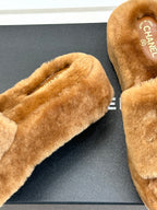 Brown plush slide slipper with CHANEL logo on insole, open toe