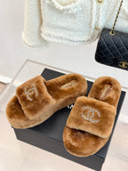 Pair of brown plush slide slippers with Chanel logo strap and rhinestone CC