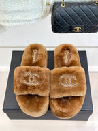 Brown plush slide slippers showing Chanel branding and rhinestone CC on straps