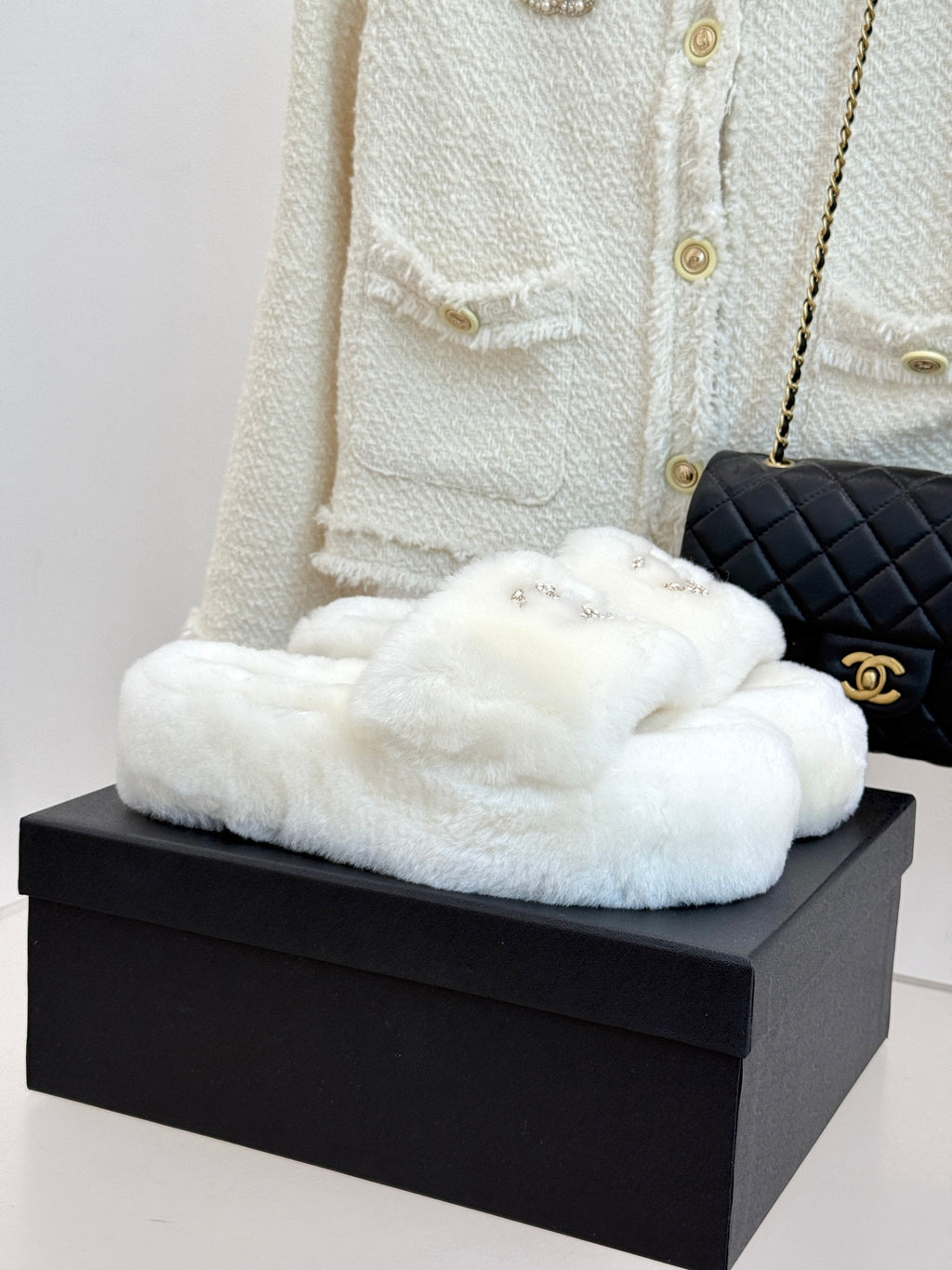 White faux-fur slide sandals with gold-tone jeweled C logo on upper