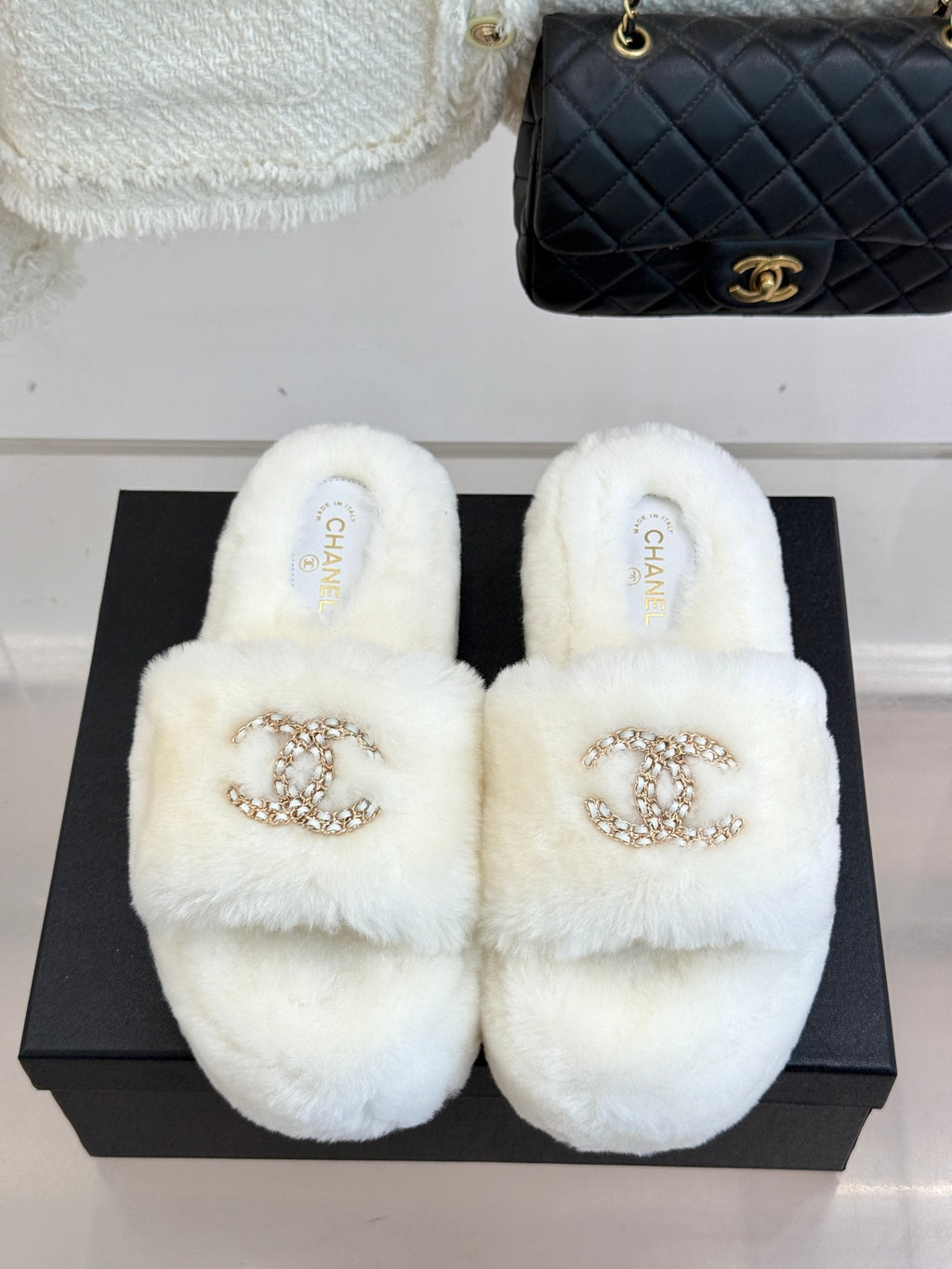 White faux-fur slide sandals with gold-tone jeweled C logo on front