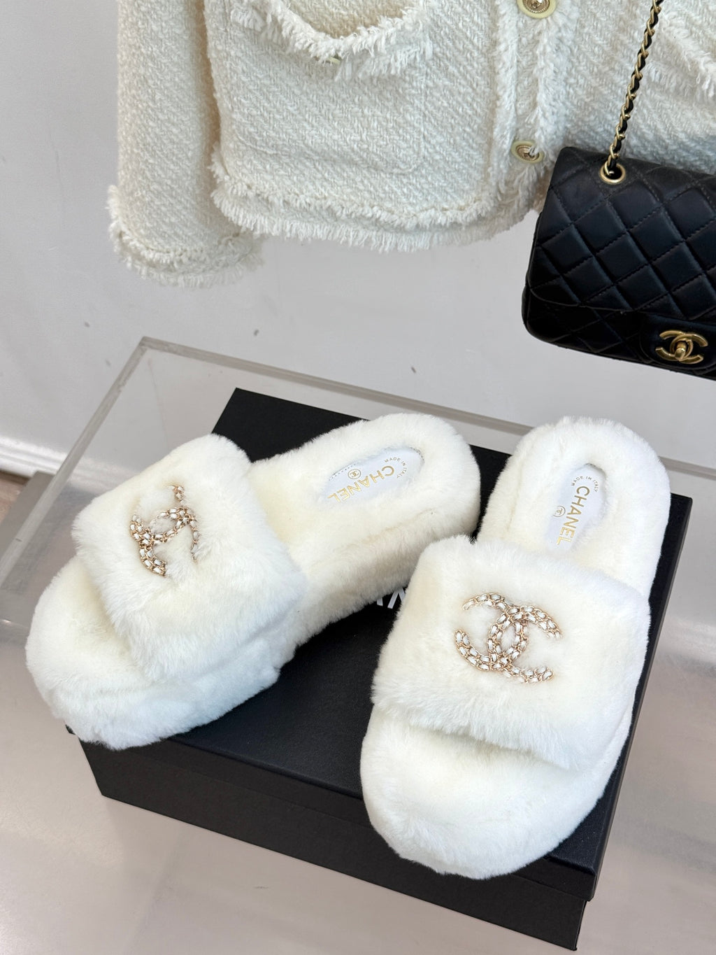 Pair of white faux-fur slides with gold-tone jeweled C logo straps