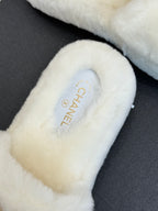 White faux-fur slide sandal with CHANEL logo on insole