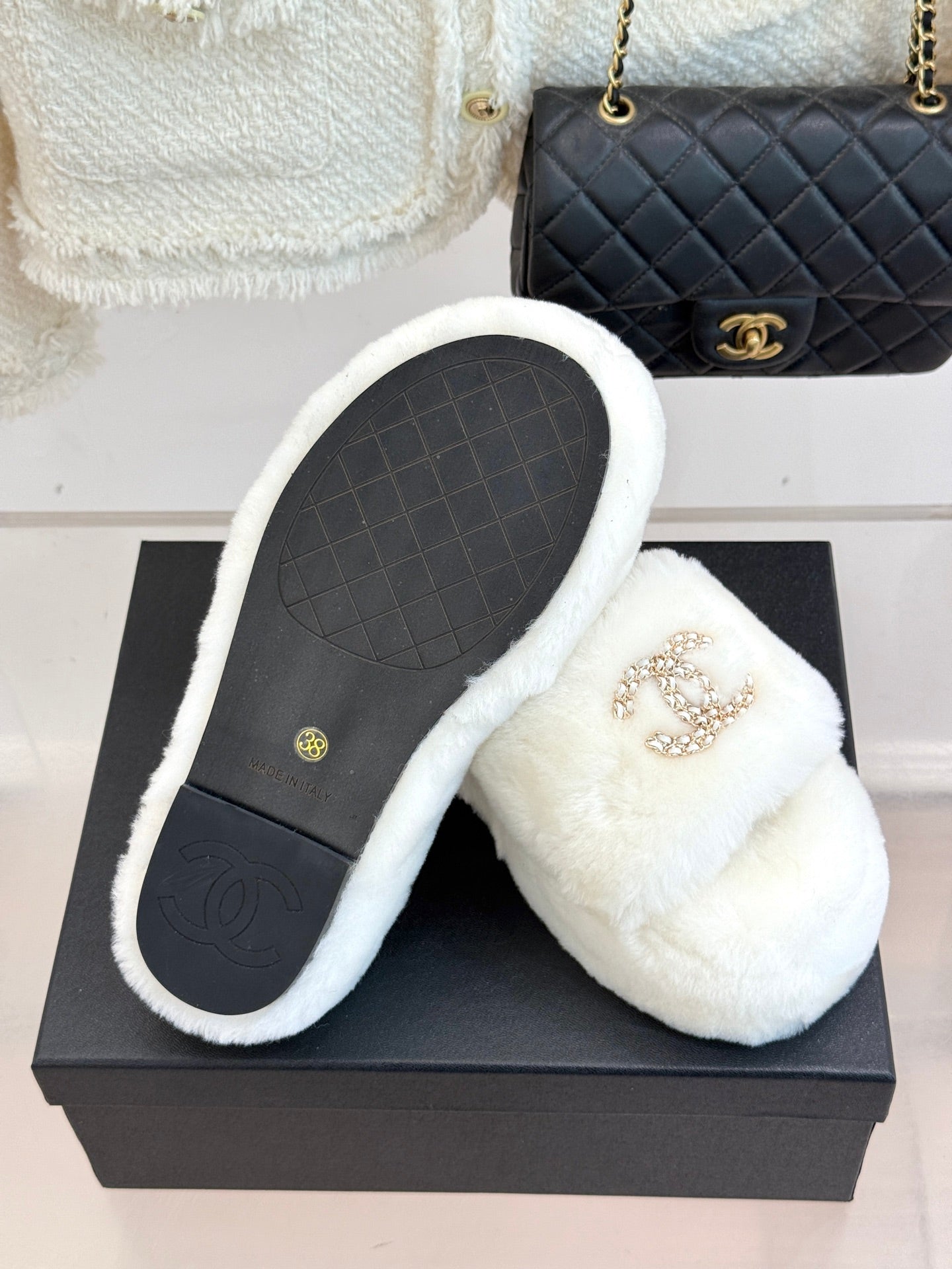 White faux-fur slide sandals with sole showing and gold-tone jeweled C logo
