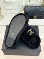 Black faux-fur CHANEL slide sandals with light gray outsole visible from above