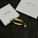 Gold-tone Dior bangle bracelet with pavé heart charm, hinged design