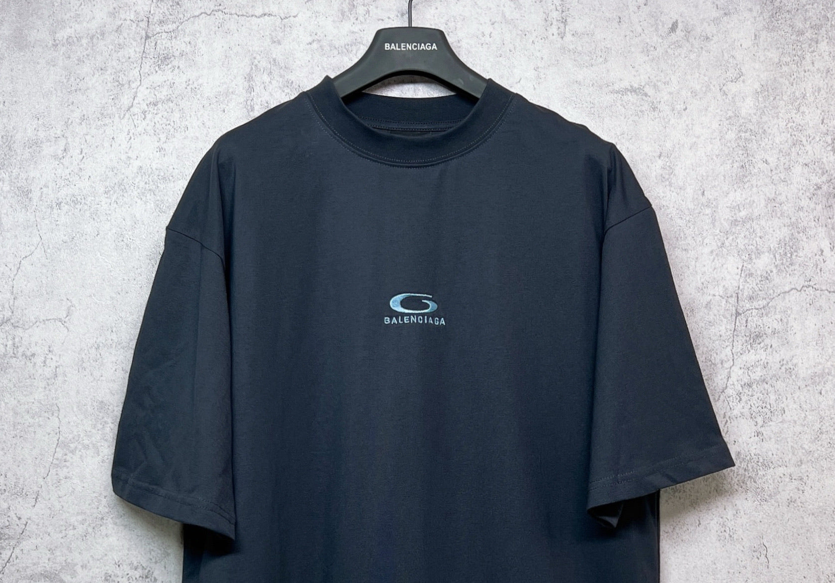 Dark navy short-sleeve T-shirt with crew neck and centered chest logo